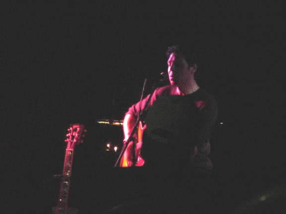 A dark photo of Kasim Sulton at Roxie's Roost, Tahlequah on 8/11/01 (it was an outside gig with limited lighting!)