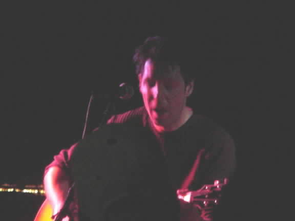 A dark photo of Kasim Sulton at Roxie's Roost, Tahlequah on 8/11/01 (it was an outside gig with limited lighting!)