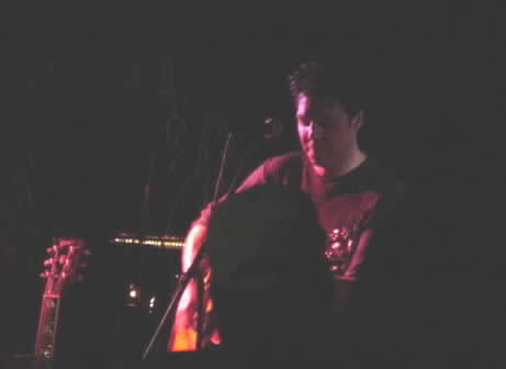 A dark photo of Kasim Sulton at Roxie's Roost, Tahlequah on 8/11/01 (it was an outside gig with limited lighting!)